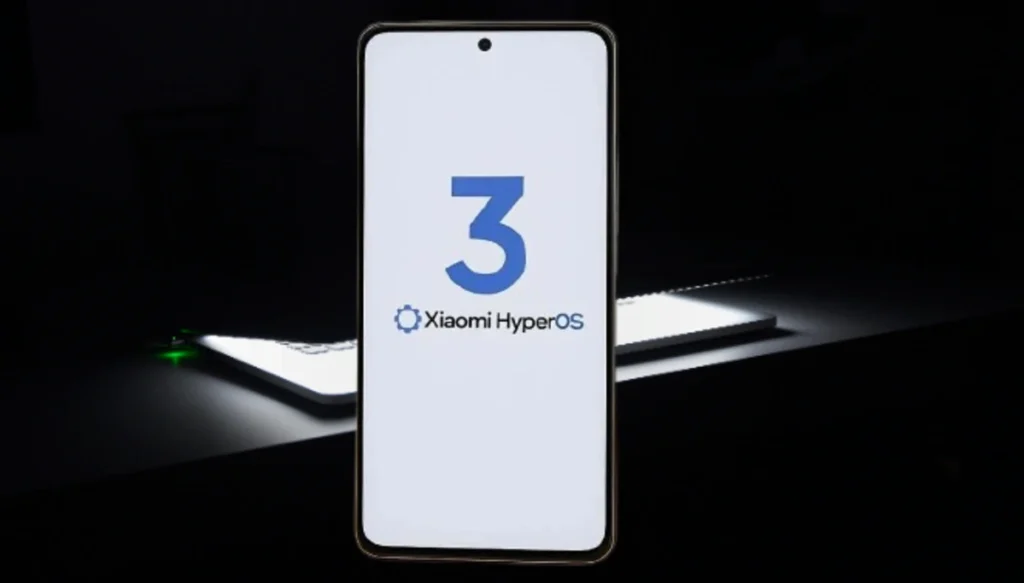 Smartphone Xiaomi exibindo a logo Atualização HyperOS 3 Xiaomi HyperOS" em tela branca, com um fundo escuro e detalhes de luz.
